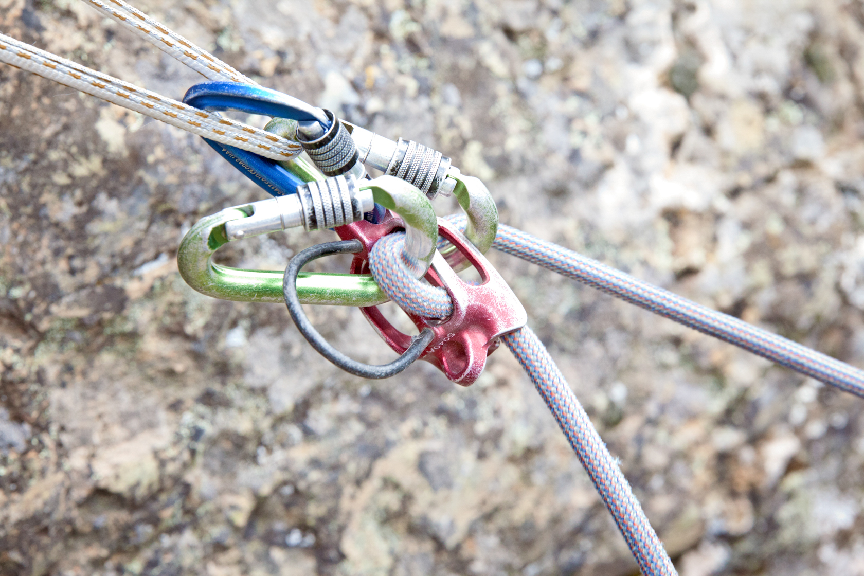 Lowering a climber from above with an auto blocking belay device.